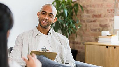 An image of a man in an office holding a clipboard