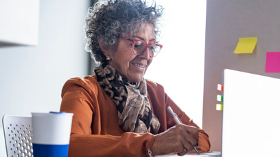 An image of a mature woman using a laptop.
