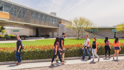 Image of several students walking across campus