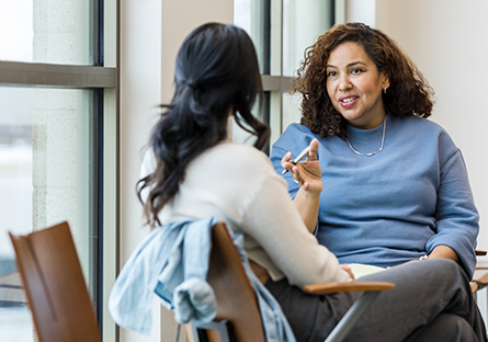 A stock image of two women talking to each other.