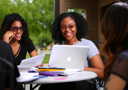 Image of smiling women working on laptop computer