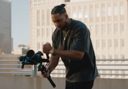 Shawn Deloney is holding a camera shooting b-roll