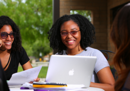 Image of smiling women working on laptops